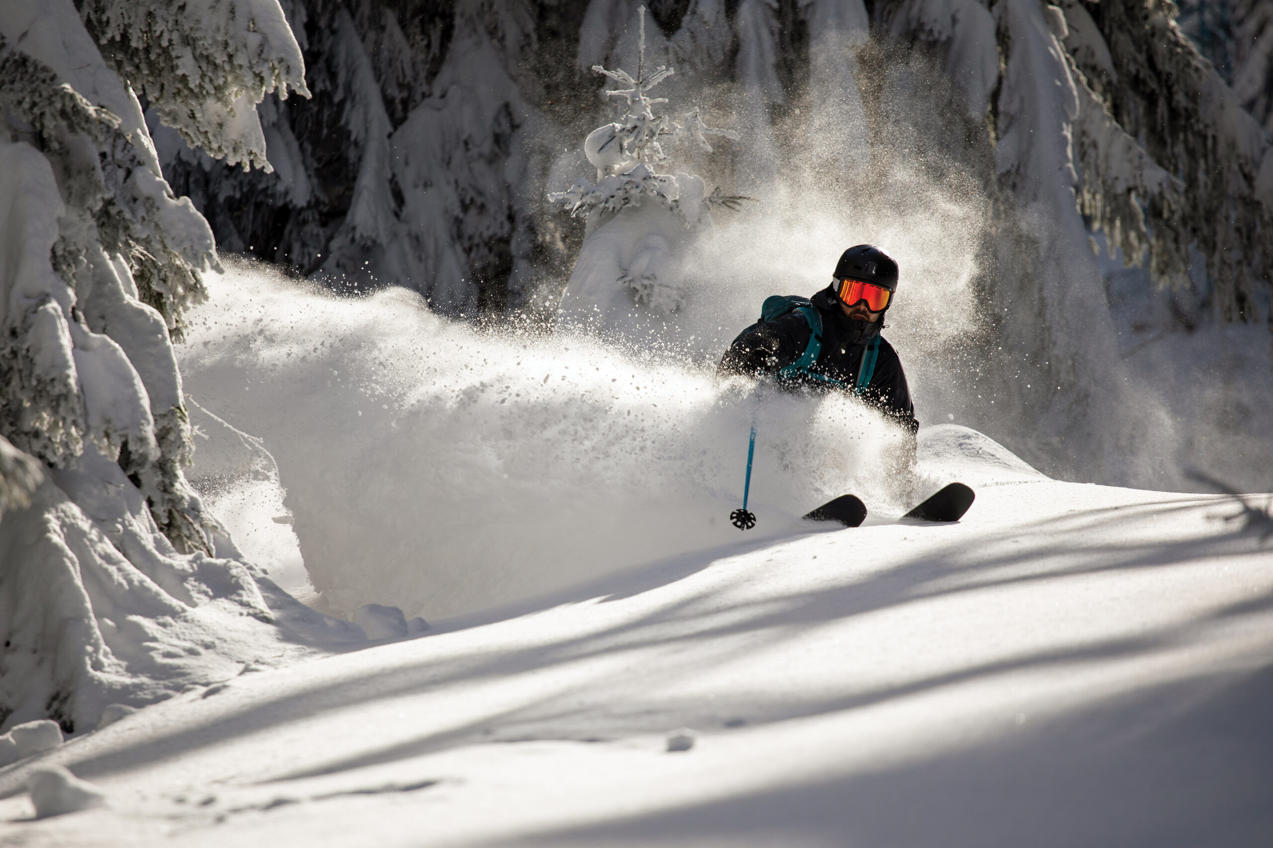 Person skiing down hill in powder snow